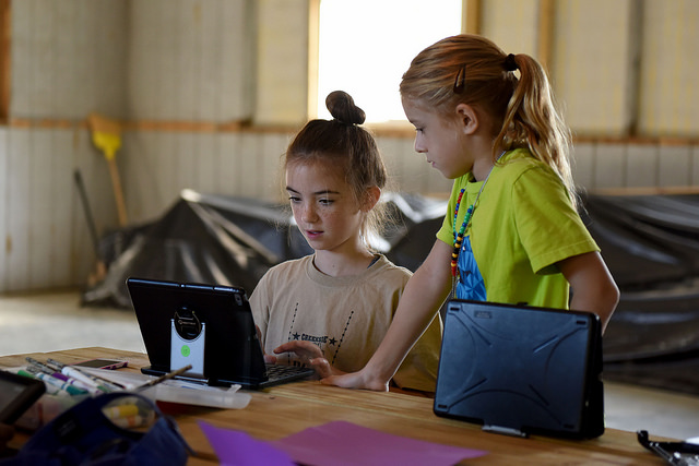 <strong>From user to creator.</strong> Children are avid users of computers but Schuman wants to encourage them to think about what--and who--is behind the screen. Courtesy US Air National Guard.
