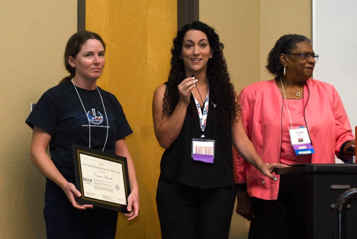 <strong>Future feature.</strong> Linda Hayden (r.) of Elizabeth City State University and Maytal Dahan (center) of TACC present a Young Professional of the Year award to TACC software engineer Carrie Arnold (l.) Courtesy Jorge Salazar, TACC.